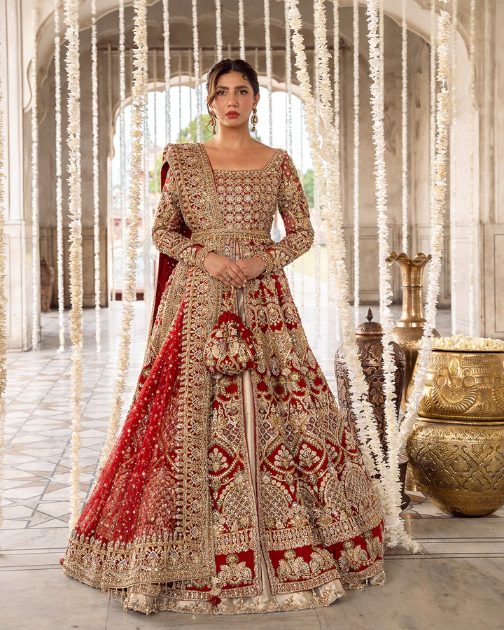 Experience timeless elegance with Juri by Mastorat, a luxurious bridal ensemble featuring a hand-embellished organza open gown, tissue lehenga, embellished net sleeves, and a delicately adorned net dupatta. Crafted with intricate zardozi, zari, sequins, crystals, and dabka work, this masterpiece is designed for brides seeking sophistication and regal charm.